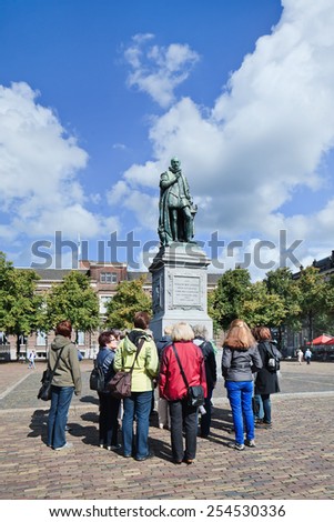 THE HAGUE-AUG. 23, 2014. Tourist group at statue William I. Frederick William I, born as William Frederick Prince of Orange-Nassau was the first King of the Netherlands from House of Orange-Nassau.