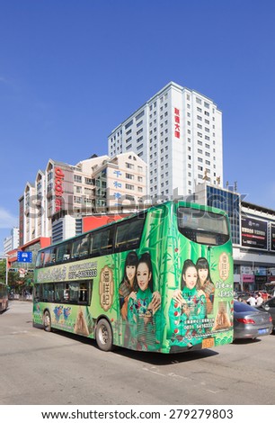 KUNMING-JUNE 30, 2014. Double decker with advertisement. China\'s outdoor advertising market has grown annually over 23% since 2000, versus 17% for overall ad market, 14% for TV, 16% for newspapers.