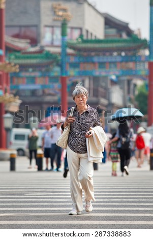 BEIJING-JUNE 9, 2015. Gray Chinese lady. The elderly population (60 or older) in China is about 128 million, one in every ten people, the world's largest. China will have 400 million elderly by 2050.