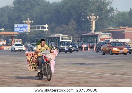 BEIJING-JUNE 1, 2013. Young boy on e-bike for flower delivery. Chinese child labor laws forbid employers employing minors. Minors are generally considered to be children under the age of 16 years.