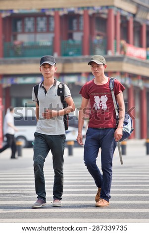 BEIJING-JUNE 9, 2015. Two young Chinese men. China faces a growing number of young men who will never marry due to the one-child policy, which has caused a birth ratio of 120 boys for every 100 girls.