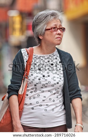 BEIJING, CHINA -JUNE 9, 2015. Female elderly in city center. Elderly population (60 or older) in China is 128 million, one in every ten people, the world\'s largest. China will have 400 million elderly by 2050