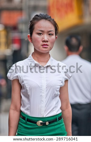 BEIJING, CHINA -JUNE 9, 2015. Young women in a shopping street. The lives of women in China have significantly changed after government made great efforts towards gender equality in a male-dominated society.