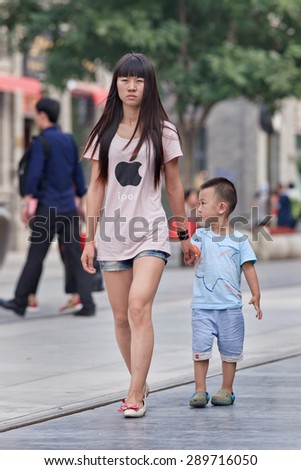 BEIJING, CHINA -JUNE 9, 2015. Young mother with her child. For decades, most urban Chinese families could have only one child. Now officials in China\'s capital asking young couples to have more children.