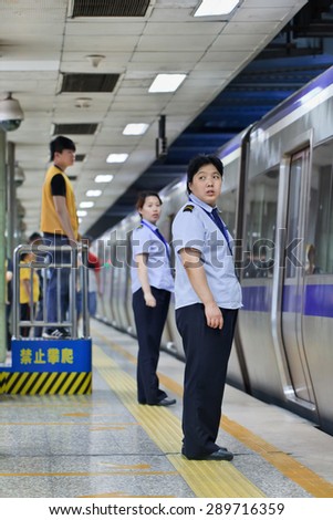 BEIJING, CHINA -JUNE 9, 2015. Personnel in subway station. Subway rail network serves Beijing urban and suburban districts with 18 lines, 319 stations, 527 KM track, averaging 9.2786 million trips per day.