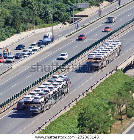 BEIJING-JUNE 30, 2015. Over sized car carrier. 16.5m is China\'s official truck length, but a large number of carriers simply flout the rules and factor fines into their rates and charges to customers.