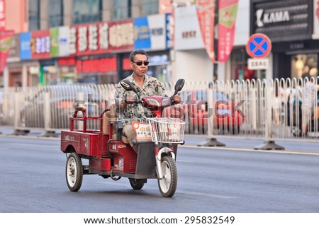 BEIJING-JULY 10, 2015. Electric freight bike. In a decade, e-bikes in China climbed from near zero to 150 million by 2015, the largest adoption of alternative fuel vehicle in history of motorization