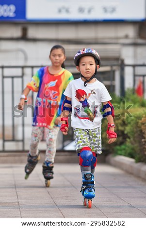 BEIJING-JULY 10, 2015. Kids practicing inline skating. Although Ping-Pong, basketball and badminton are China's top sports, last decade inline skating became increasingly popular among Chinese youth.