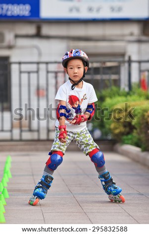 BEIJING-JULY 10, 2015. Boy practicing inline skating. Although Ping-Pong, basketball and badminton are China\'s top sports, last decade inline skating became increasingly popular among Chinese youth.