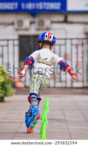 BEIJING-JULY 10, 2015. Boy practicing inline skating. Although Ping-Pong, basketball and badminton are China's top sports, last decade inline skating became increasingly popular among Chinese youth.