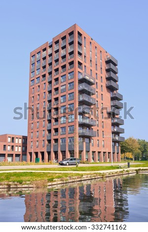 TILBURG-HOLLAND-OCT. 4, 2015. Modern apartment building near a canal. Rented housing is provided by social housing sector and non-subsidized sector. Holland counts about three million rented homes.