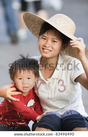 HAINAN - CHINA, JAN. 12. Chinese Mother with her unidentified son in Hainan, China on January 12, 2008. China?s family planning policy is introduced in 1978 and restricts couples to have only one child.