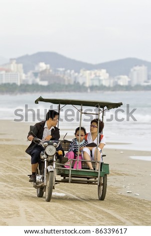 SANYA,CHINA-JAN. 25:Family in a motor taxi in Sanya on Jan. 25, 2008. It is a tourist destination city located at the southernmost of China (Hainan Province) and renowned for its tropical climate.