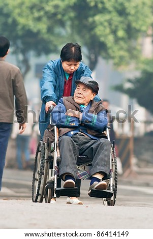 GUANGZHOU - JAN. 8. Old Chinese man in a wheel chair. China\'s elderly population (60 or older) is about 128 million, one in every ten people, the largest in the world. Guangzhou, Jan. 8, 2008.
