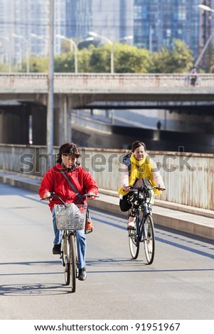 BEIJING - OCT. 25. Two women cycles in a Beijing suburb on Oct. 25, 2011. From 1995 to 2005, Chinas bike fleet declined by 35 percent and private car ownership more than doubled.