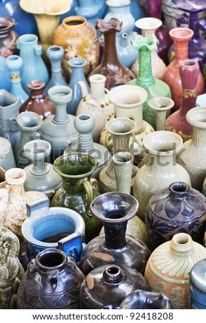 Collection of multicolored, old vases an jars at a Chinese outdoor market.