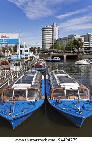 AMSTERDAM - JULY 21, 2009. Moored cruise boats in a canal on July 21, 2009. Amsterdam is the most watery city in the world. Its canals and harbors fill a full quarter of the city\'s total surface.