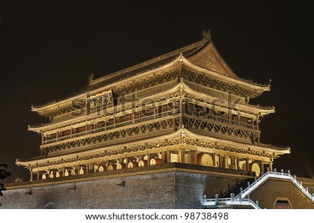 The illuminated ancient Drum Tower located at the ancient city wall by night time, Xian, Shanxi Province, China