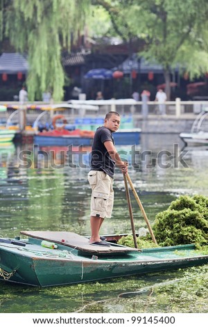 BEIJING-AUG. 23, 2010. Migrant worker on a boat on Aug. 23, 2010 in Beijing. According to 2010 census figures China\'s migrant population now numbers 221 million, or 16.5 percent of all citizens.