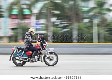 GUANGZHOU-FEB. 26, 2012. Man on a Honda motorcycle on Feb. 26, 2012 in Guangzhou. Honda was founded at 24 September 1948 and has been the world's largest motorcycle manufacturer since 1959.