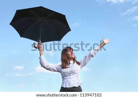 Surprises of weather.The young woman in a white blouse and a black skirt with black umbrella.