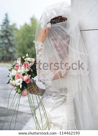 Bride. The bride covers veil her face.