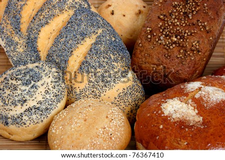Bread Different types of bread: long loaf with poppy, buns with poppy and with onion, bun with powdered sugar, rye-bread