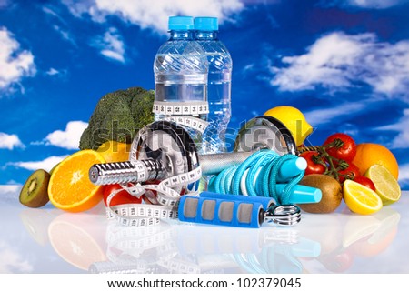 fitness dumbbells, water, hand grip and fruits