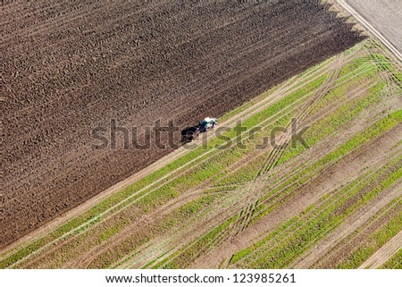 tractor on harvest field aerial view
