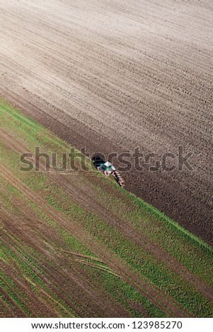 tractor on harvest field aerial view
