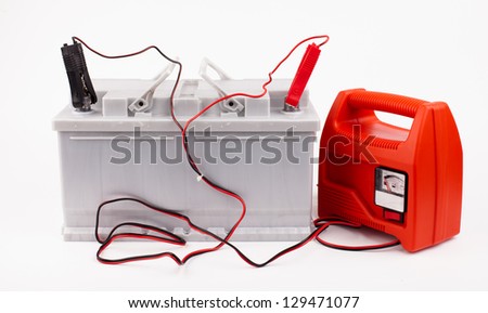 Car battery with two jumper cables clipped to the terminals isolated on white
