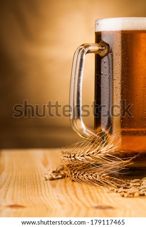 Glass of light beer on table