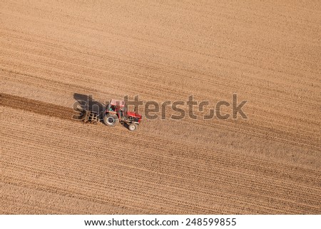 aerial view of harvest fields with tractor  in Poland