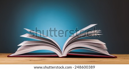 book on wooden table  with blue background