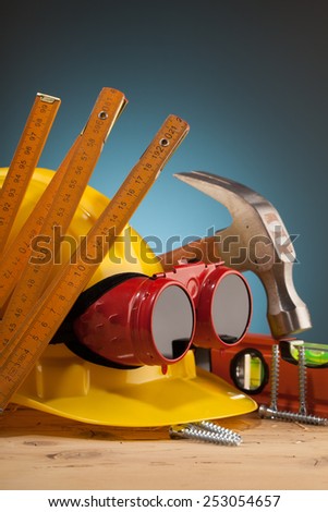 yellow helmet and wood mounting tools on wooden table