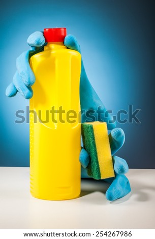 colorful cleaning equipment on table and blue background