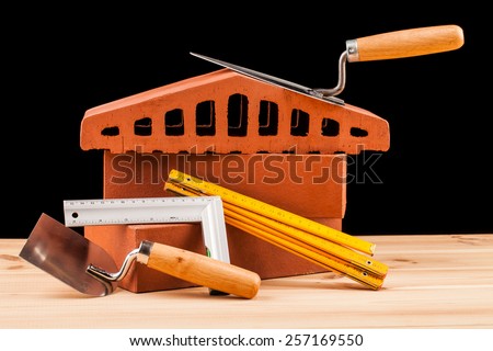 builder  tools on black background and wooden table