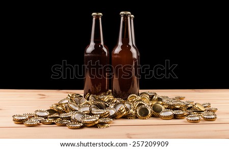 bottles  of homemade beer  and bottle caps on table