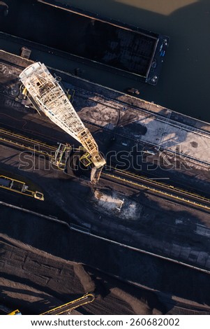 moving crane with a heap of coal next to the coal power plant in Wroclaw city in Poland