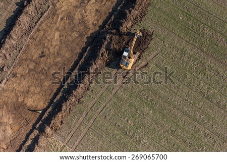 aerial view of long arm excavator working on the field in Poland