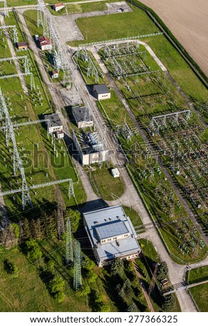 Aerial image of electrical substation featuring wires, transformers and large scale power energy towers in Poland