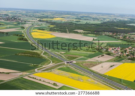 aerial view of highway and green harvest fields in Poland