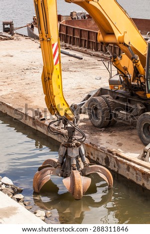 long arm excavator working on river bank in  Wroclaw Poland