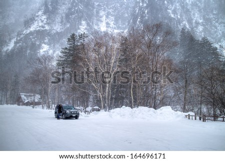 Hokkaido, Japan-Feb.2: A car was in a big snowstorm at snow mountain area. The temperature was -10 deg.C and the car was hardly to be driven. Feb.2 in Hokkaido, Japan.