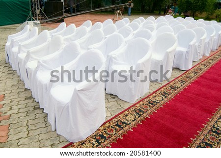 white covers on chairs before a concert