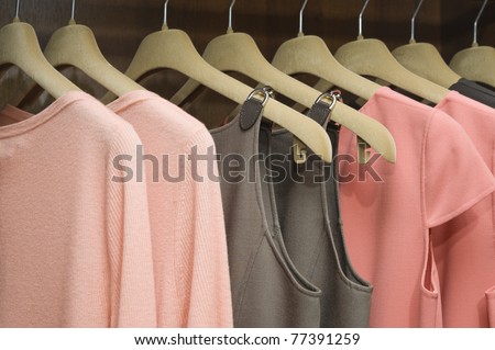 Colorful collection of women\'s clothes hanging on a rack