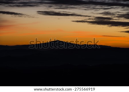 Silhouette of mount Amiata at sunset in Winter, Apennines, Umbria, Italy