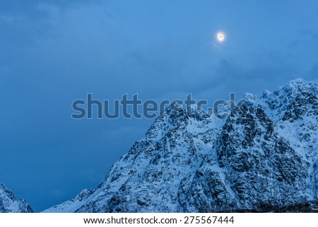 Mountain peak with snow and the Moon, Hamnoy Island, Lofoten, Norway