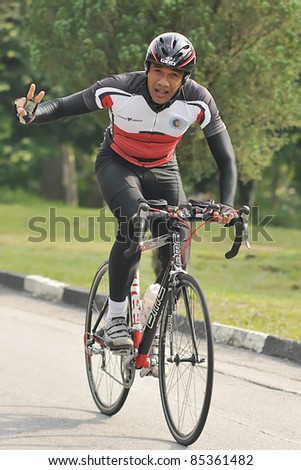 KUALA LUMPUR, MALAYSIA- SEPT. 24: An unidentified participant cycles after run 5km at  Malakoff  University Duathlon Series  2011, on September 24, 2011 in Kuala Lumpur, Malaysia