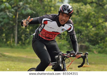 KUALA LUMPUR - SEPT 24: An unidentified participant cycles after run 5km at Malakoff University Duathlon Series 2011, on September 24, 2011 in Kuala Lumpur, Malaysia